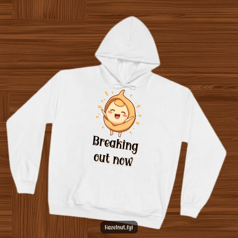 Funny hoodie with a joyful hazelnut character emerging from a stylized shell, symbolizing liberation and happy energy.