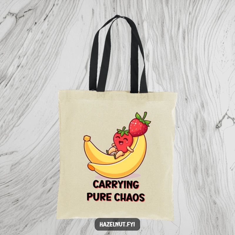 Funny tote bag showcasing a strawberry joyfully sliding down a banana peel, ideal for a humorous and practical accessory.
